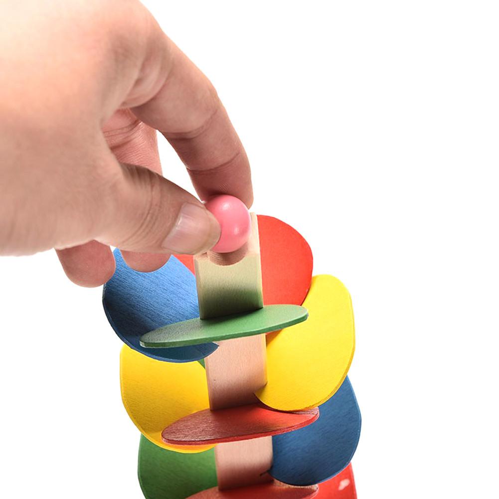Child developing motor skills with marble tree