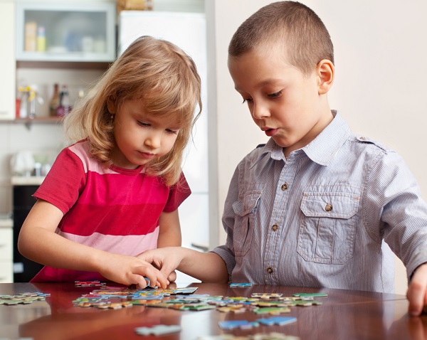 Children sharing a puzzle