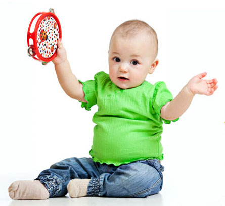 Child playing colourful wooden tambourine